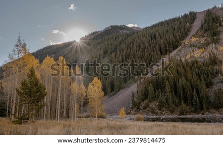 The Flare of sunrise at The Maroon Bells on an early autumn morning in Aspen, Colorado.