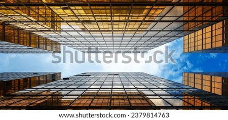 Golden skyscrapper building with blue sky in Hong Kong. Windows glass of modern office architecture design. Architecture exterior for cityscape background.