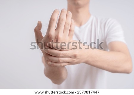 Pain and numbness in fingertips and palms.man massaging him sore hand,
