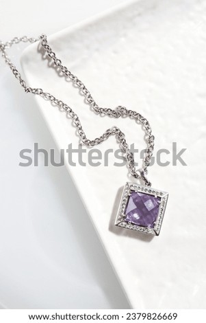 Beautiful necklace with gemstone on white table, top view Royalty-Free Stock Photo #2379826669