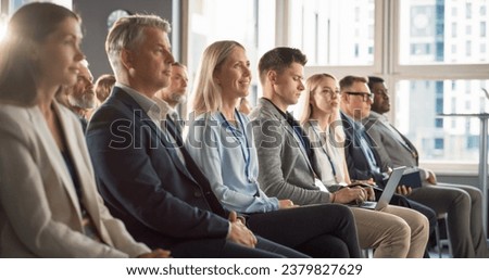 Caucasian Woman Sitting in Crowded Audience at Human Resource Forum. Female Delegate Focused On Presenter. HR Manager Listening to Inspirational Entrepreneurship Presentation About Social Studies Royalty-Free Stock Photo #2379827629