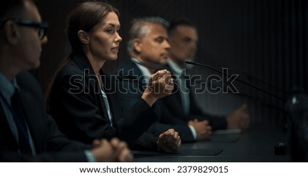 Caucasian Female Head Of Political Delegation Speaking At International Ecology Forum Press Conference. High-Profile Politician Reporting On Successful Deal. Focused Diverse Delegates Listening Royalty-Free Stock Photo #2379829015
