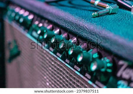 Knobs on Guitar Amplifier closeup, macro photo Royalty-Free Stock Photo #2379837511