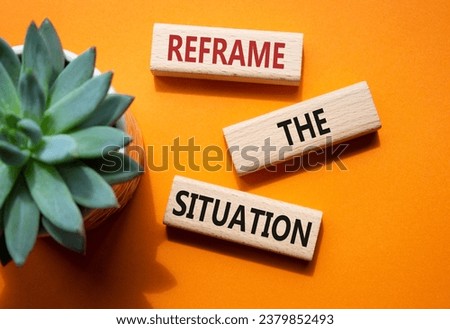 Reframe the situation symbol. Concept words Reframe the situation on wooden blocks. Beautiful orange background with succulent plant. Business concept. Copy space.
