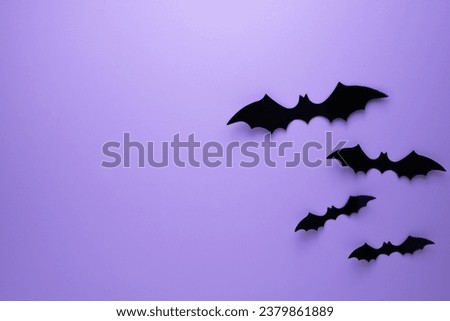 Happy Halloween holiday concept. Halloween decorations on purple background. Halloween party greeting card mockup with copy space. Flat lay, top view, overhead.