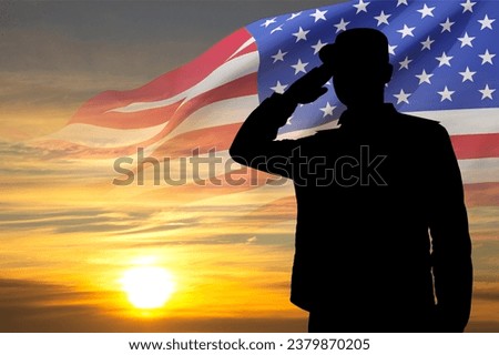 Silhouette of soldier with USA flag against the sunset. Greeting card for Veterans Day, Memorial Day, Independence Day