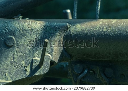 Abstract photo of the iron structure of an old unused agricultural machine. Detail of iron construction, old machine, industrial, material, iron, brown paint.