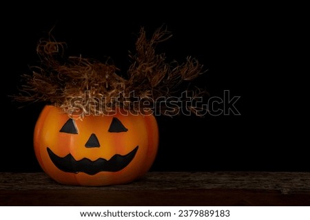 A spooky pumpkin on black background.