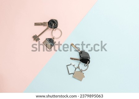 Keys with keychain with shape of house on a two colored background