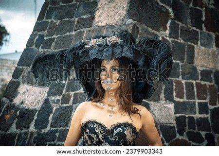 Woman dressed as catrina outdoors with hat and skull makeup