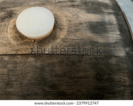 bung hole in wooden barrel with rubber bung cork in hole used for aging wine ales or spirits background  Royalty-Free Stock Photo #2379912747