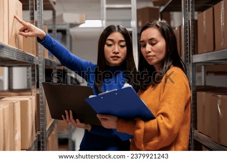 Warehouse worker and supply chain manager tracking inventory in storage room. Storehouse employees planning parcel stocking process optimization, analyzing orders checklist on clipboard