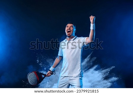 Padel tennis player with racket. Man athlete with paddle racket on court with neon colors. Sport concept. Download a high quality photo for the design of a sports app or website.
