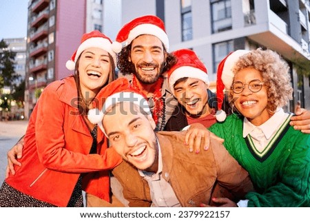 Group of Friends wearing Santa Claus hat. People celebrating Christmas outdoors. High quality photo