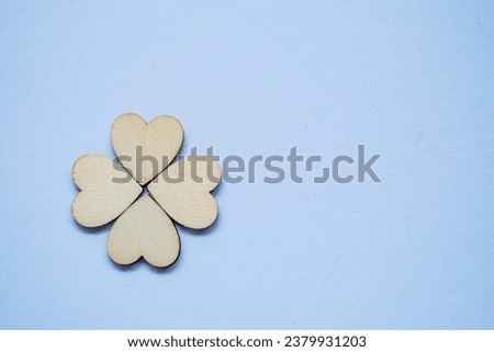 Four wooden heart on white surface