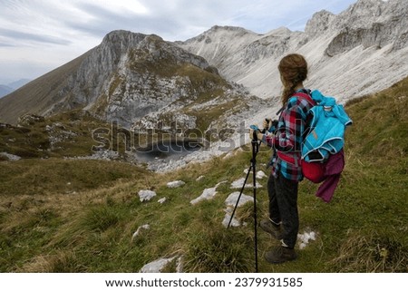 Adult Woman Hiking on Luznica Lake or the third lake of Krn that  is a glacial lake in the Triglav national park of Slovenia