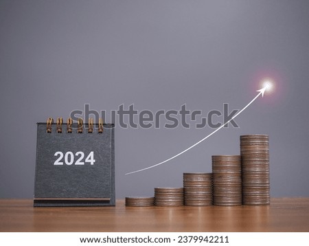 2024 desk calendar, Stack of coins with arrow rising. The concept of business growth, Financial investment, Market stock, Profit return, Dividend and Business fund in New Year 2024