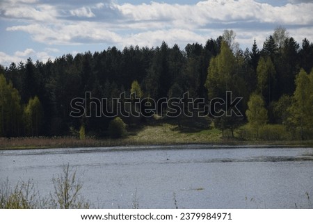 Picturesque landscape of calm lake and forest in Latvia. Stock Photo