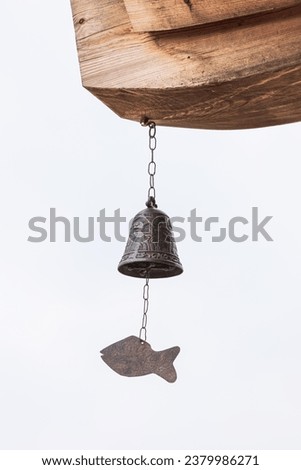 fish-shaped bell under the eaves. Wind chime, Wind Bell  Royalty-Free Stock Photo #2379986271