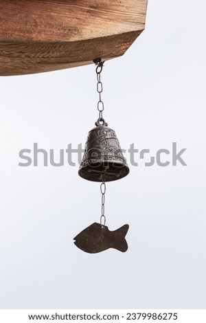 fish-shaped bell under the eaves. Wind chime, Wind Bell  Royalty-Free Stock Photo #2379986275