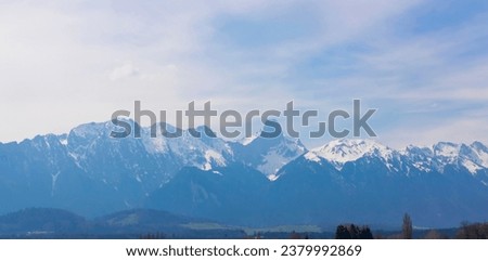 The mountain view of alpine as snow-capped mount peaks in Winter mountains