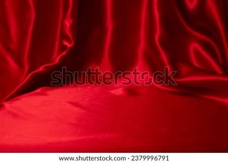 staged red satin with folds and empty space for text or product placement Royalty-Free Stock Photo #2379996791