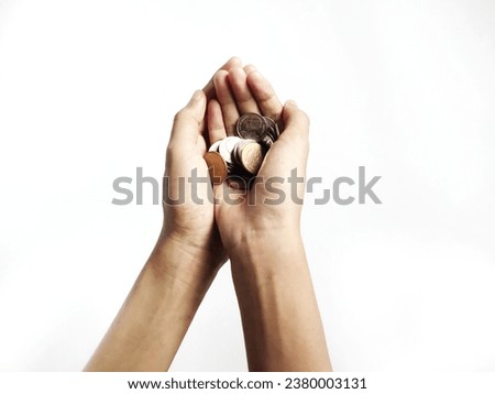 Both hands held a small amount of money in their hands as if it were the most valuable thing. Royalty-Free Stock Photo #2380003131