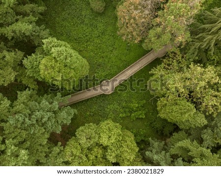 Wood promenade in a forest. Aerial view about a green area with wooden walkway. Jeli arboretum near by Kám town, Hungary, Europe Royalty-Free Stock Photo #2380021829