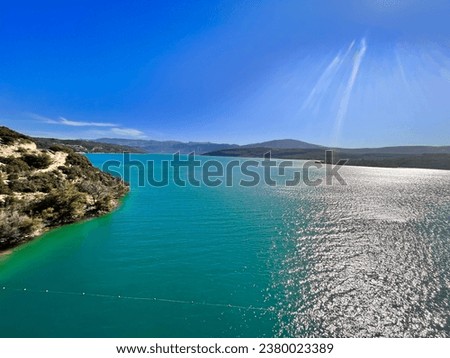 Spectacular beautiful azur blue lake with the mountains on the background with clear blue sky - photo France Verdon August 2 2023, unique mountain lake, view from top