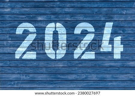 2024 written on a blue wooden wall.