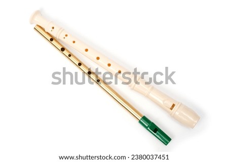 Irish whistle and block flute are longitudinal flutes with a whistle device and playing holes. Royalty-Free Stock Photo #2380037451