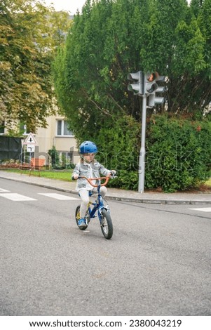 Little girl to ride public bike on traffic playground in Prague, Czech republic. High quality photo