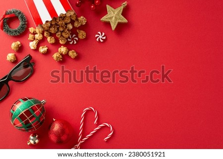 Holiday movie marathon with popcorn inspiration. Overhead photo of 3D glasses, tasty striped box popcorn, festive baubles, star decoration, mini wreath, sweets on a red background with room for text
