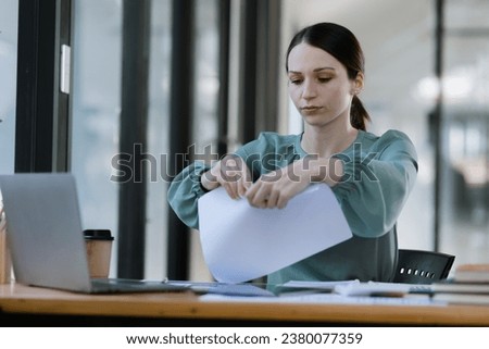 Businesswoman stressed and tired from work sitting in office desk, Unhappy woman feeling stressed.