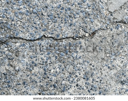 a concrete wall with a crack in it.