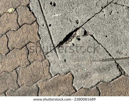 a crack in the sidewalk.