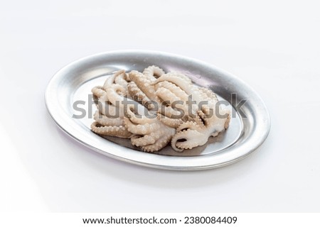 Squid tentacles cut into pieces in a dish for cooking. Squid tentacles for grilling dishes Pictures for designing food menus