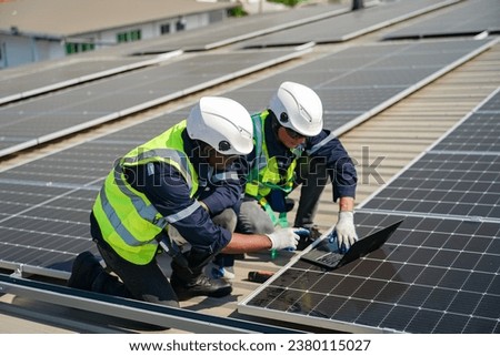 Engineer service check installation solar cell on the roof of factory. technician checks the maintenance of the solar panels, engineering team working on checking and maintenance in solar power plant Royalty-Free Stock Photo #2380115027