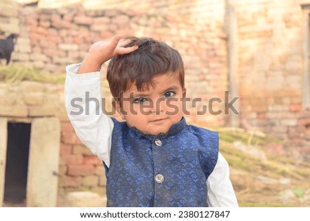 Portrait of asian Pakistani Islamic boy wearing Islamic dress. Pakistani Younger baby boy with Islamic culture dress against
Beautiful natural background.Pakistani kid.with selective focus on subject.