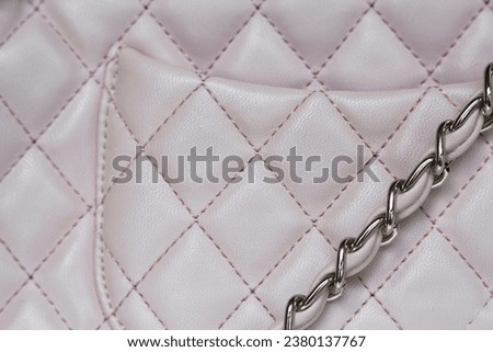 close up of a chain and leather bag detail