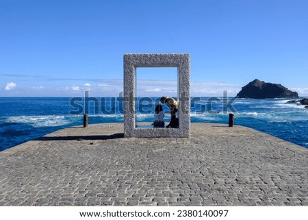 Tourists taking pictures at a viewpoint in Garachico