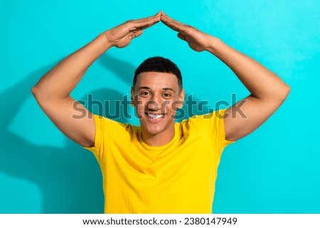 Photo of young positive man show arms defense protection against russian rockets stop war ukraine isolated on aquamarine color background