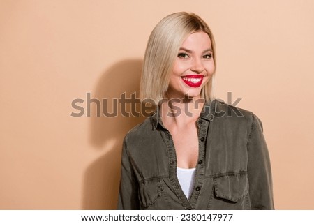 Closeup photo of attractive model lady red plump lips white veneers teeth wearing khaki shirt isolated beige color background
