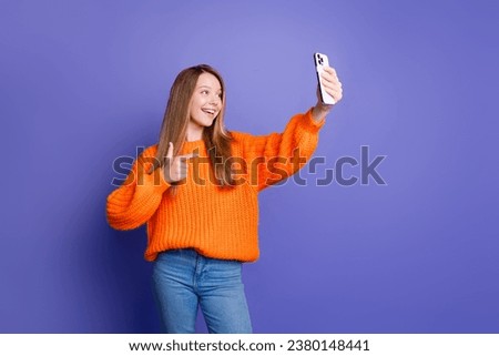 Young teenage girl gesture finger symbol photo subscribers are cool takes selfie shot using smartphone isolated on violet color background