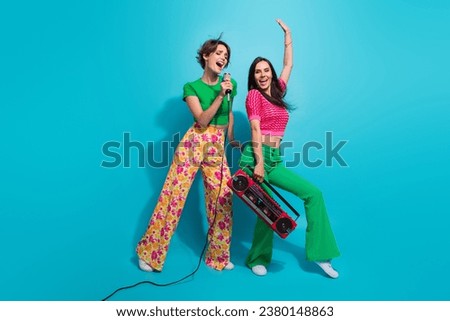 Full body photo happy excited funky good mood girlfriends singers microphone cassette boombox disco vibe isolated on blue color background