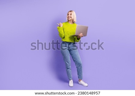 Full length photo of cheerful dreamy woman dressed knitted sweater studying device thumb empty space isolated violet color background