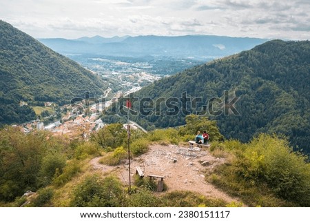 Two happy hiker couple reaching a goal, conquering a hill top enjoying in nature