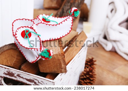 Firewood with Christmas shoes on wooden floor background