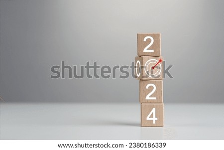 2024 Goals of business or life. Wooden cubes with 2024 and goal icon on smart background. Starting to new year. Business common goals for planning new project, Business target achievement. Royalty-Free Stock Photo #2380186339