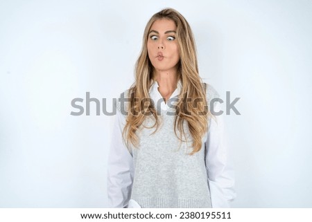 young beautiful woman making fish face with lips, crazy and comical gesture. Funny expression.